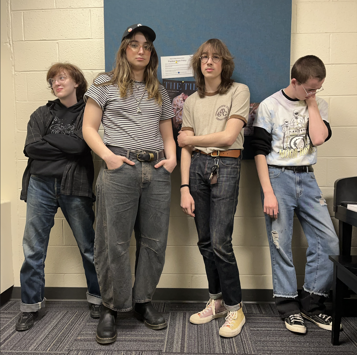 Picture of the 4 band members, posing for a group photo.